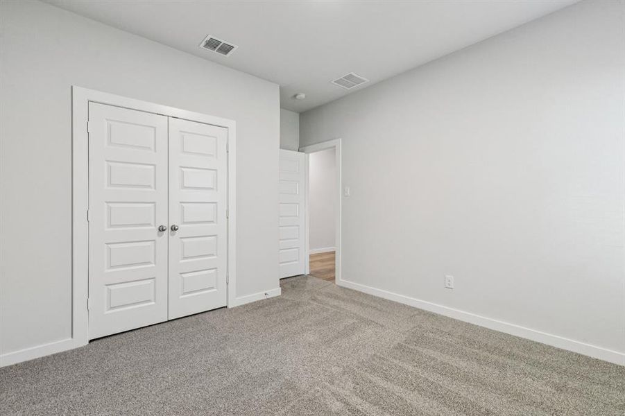 Bedroom in the Oscar home plan by Trophy Signature Homes – REPRESENTATIVE PHOTO
