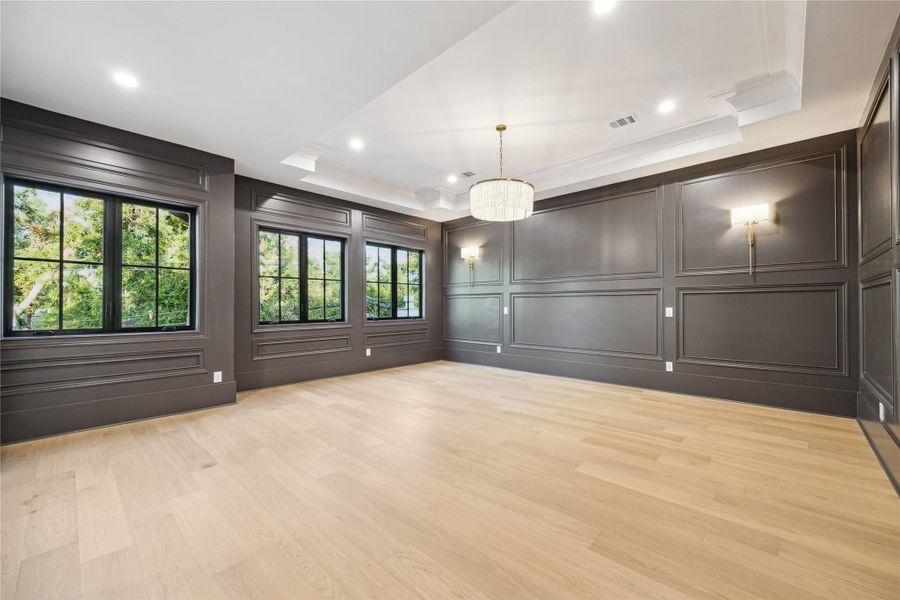 Primary bedroom features boxtray ceiling, custom trim elements and large windows   *this photo has been virtually rendered based on a previous home constructed by the builder. 1519 Candlelight may have different selections at builders sole discretion. These photos are not meant to be an exact representation of 1519 Candlelight.