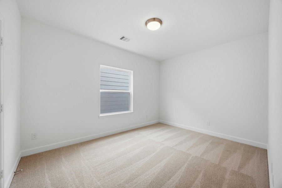 Perfectly sized, this secondary bedroom features a walk-in closet with custom shelving for maximum organization.