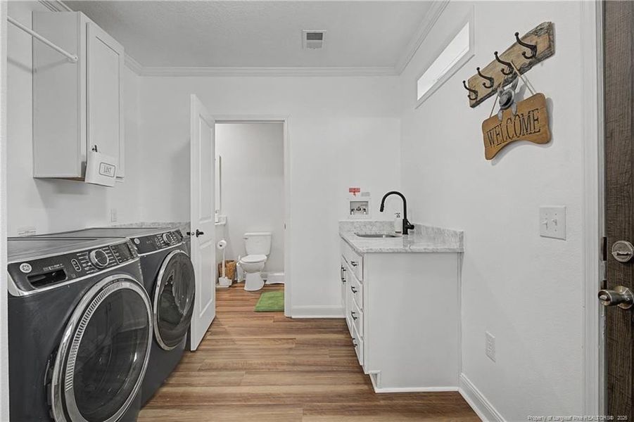 Utility room connecting to guest bath
