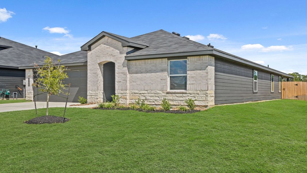 Front exterior of a new home in Grand Pines, Magnolia, TX, highlighting curb appeal (Image 21). Front exterior of a new home in Grand Pines, Magnolia, TX, highlighting curb appeal (Image 21).