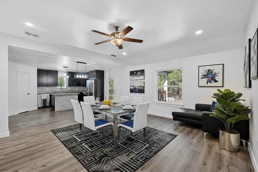 Dining room with light wood-style flooring, ceiling fan, a textured ceiling, and recessed lighting