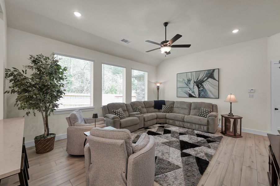 Expansive living and dining area with soaring ceilings, upgraded lighting fixtures, and seamless flow throughout the main living spaces.