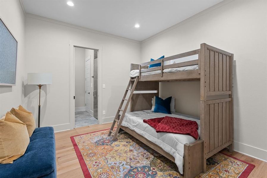 Bedroom with crown molding, light wood-style flooring, connected bathroom, and recessed lighting