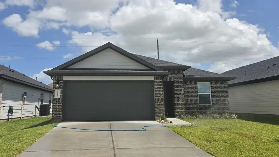 Front exterior of a new home in Tamarron, Fulshear, TX, highlighting curb appeal (Image 1). Front exterior of a new home in Tamarron, Fulshear, TX, highlighting curb appeal (Image 1).