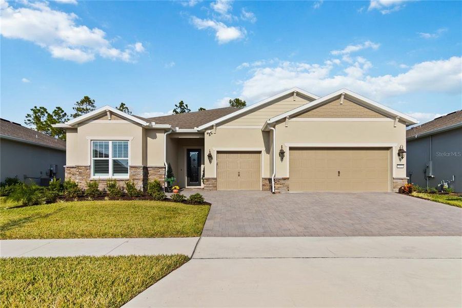 Front exterior of a new home in Del Webb Sunbridge, St. Cloud, FL, highlighting curb appeal (Image 25).