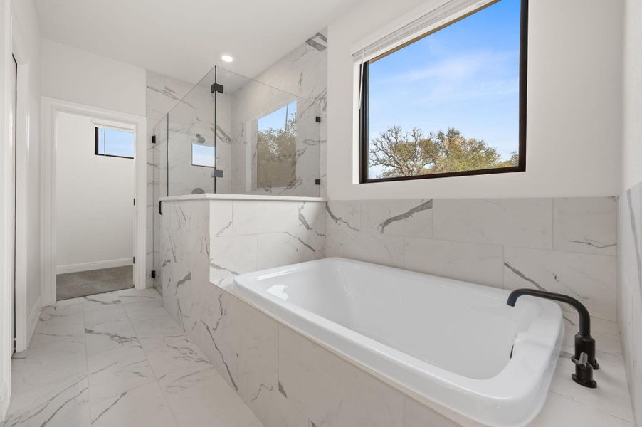 Huge walk in shower and separate soaking tub in primary ensuite bath