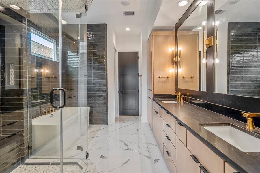 This spa bathroom is where you will get away from it all. Wall-to-wall mirrors, sconces for ambient lighting, and an all neutral color palette inside this primary bath.