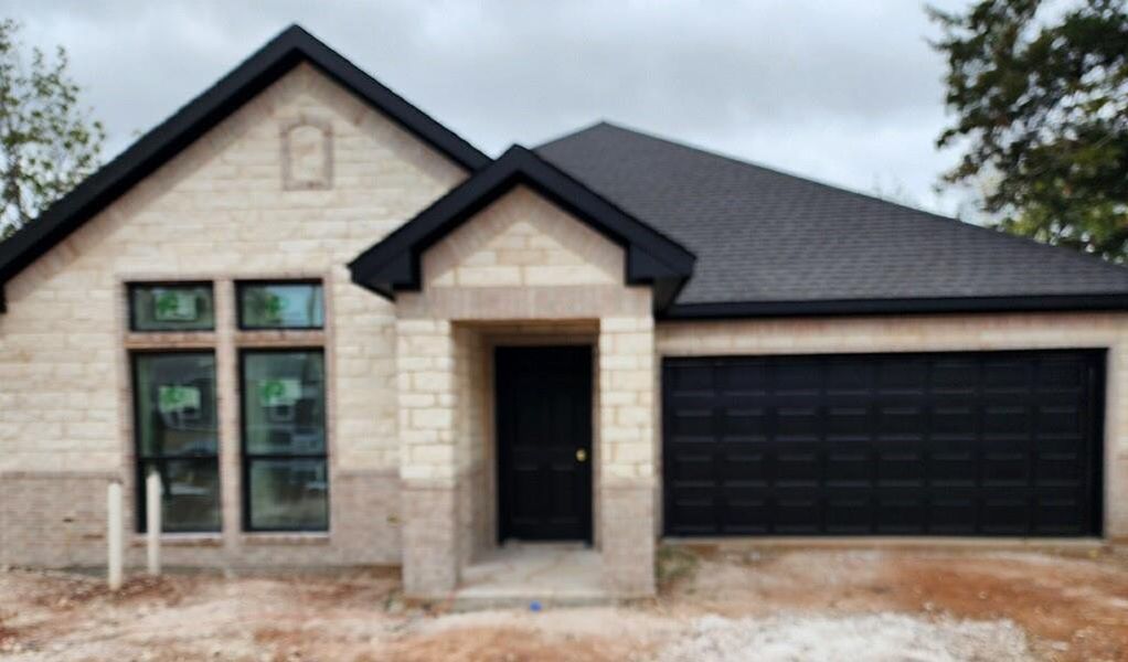 View of front of property featuring a garage