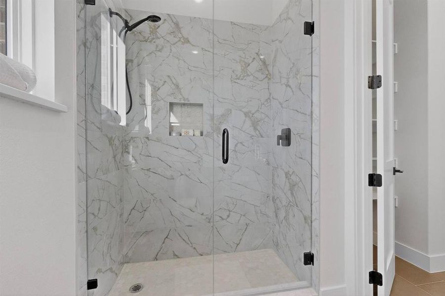 Full bath featuring a marble finish shower