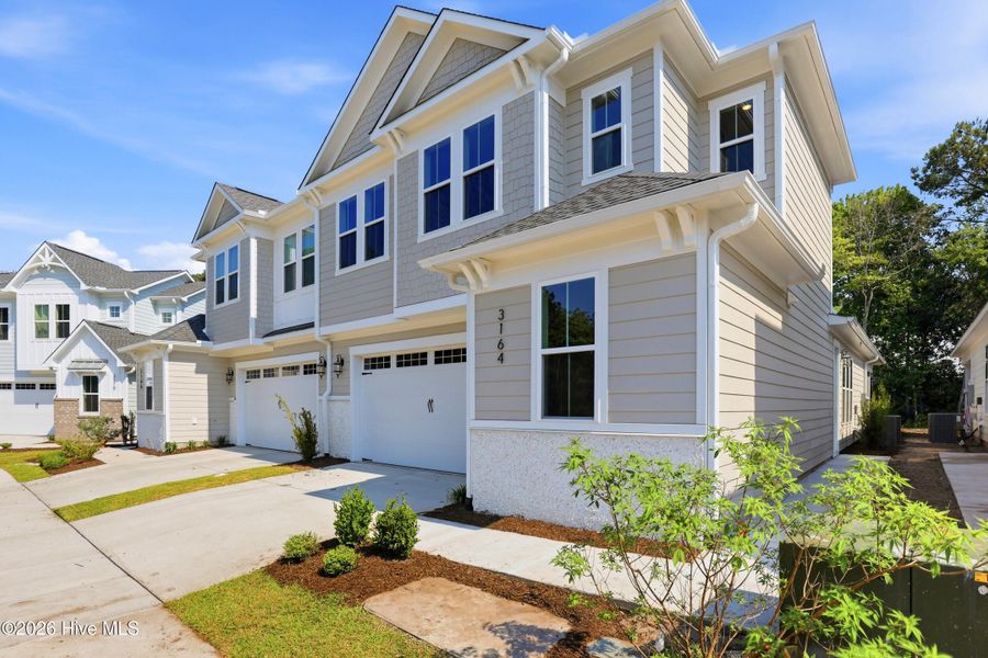 Front exterior of a new home in East & Mason, Wilmington, NC, highlighting curb appeal (Image 23). Front exterior of a new home in East & Mason, Wilmington, NC, highlighting curb appeal (Image 23).