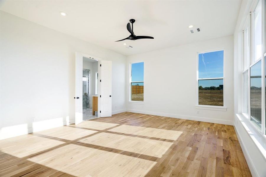 Spare room with ceiling fan and light hardwood / wood-style floors