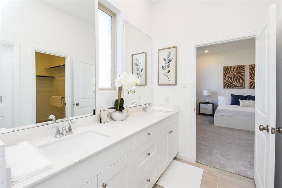 Reflected in the mirror, left, is your primary walk-in closet; while your refreshing ensuite bath is just footsteps from your primary paradise.