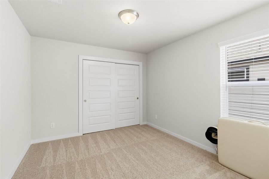 Take a look at your second bright and comfortable secondary bedroom that provides ample space for family, guests, or a dedicated home office, complete with a generous closet.