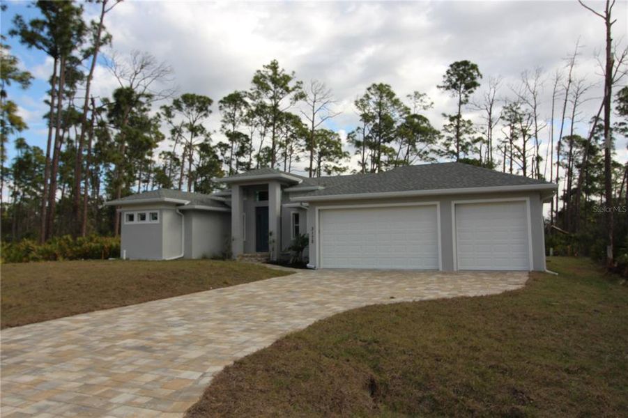 Front exterior of a new home in , Port Charlotte, FL, highlighting curb appeal (Image 15).