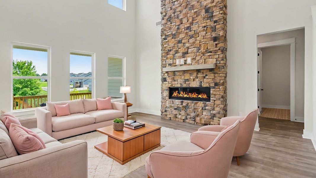Gathering room with stone fireplace, high ceilings, and hard surface flooring Gathering room with stone fireplace, high ceilings, and hard surface flooring