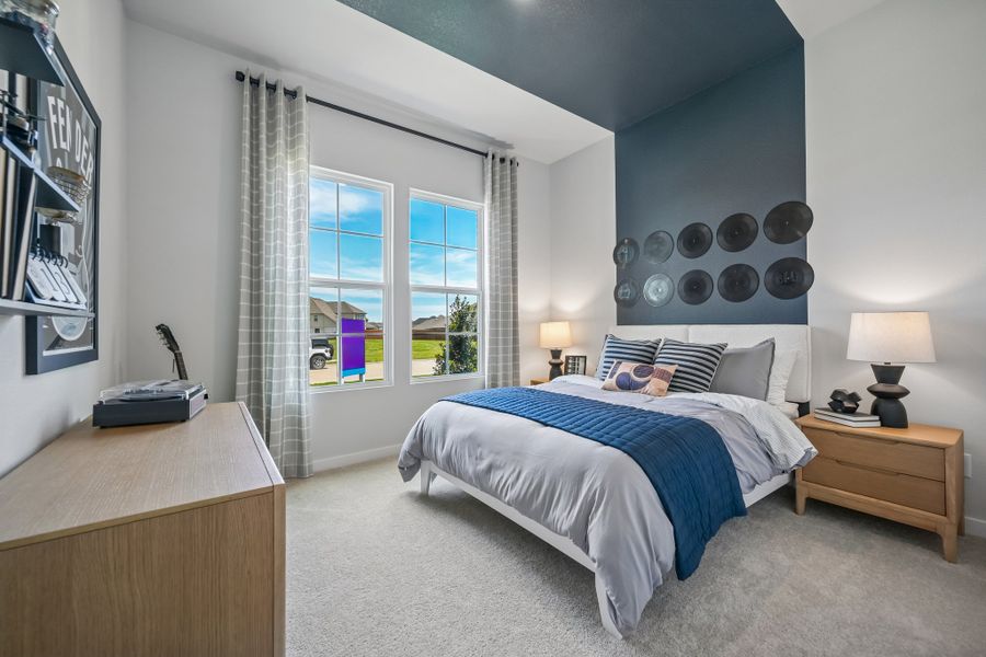 A bedroom with a bed and a desk.