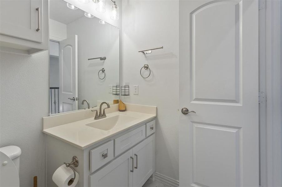 Bathroom featuring vanity and toilet