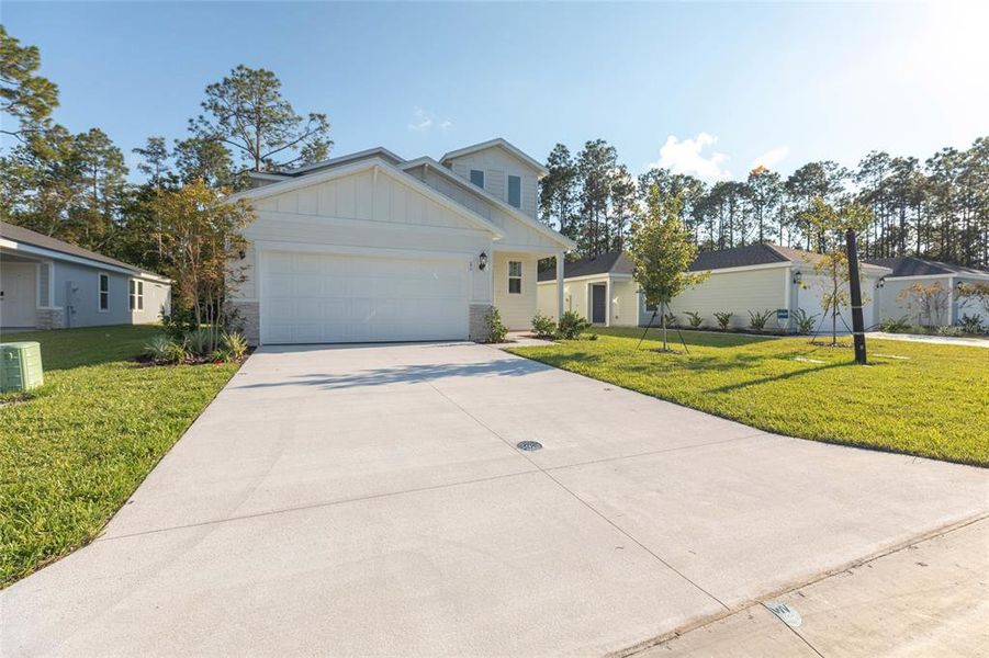 Front exterior of a new home in Flagler Village - Classic Series, Palm Coast, FL, highlighting curb appeal (Image 1).