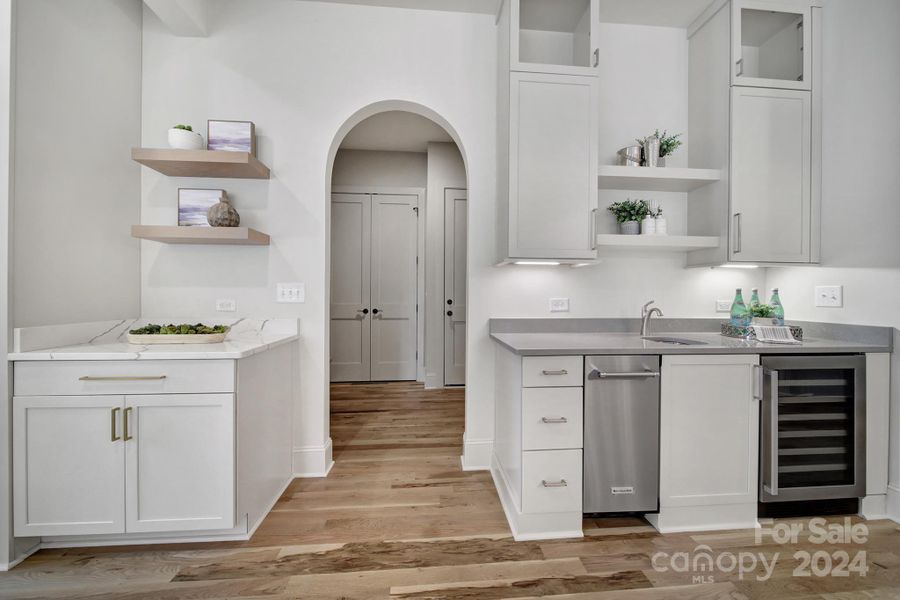 Brilliant bar area with wine refrigerator, ice maker and additional cabinetry.