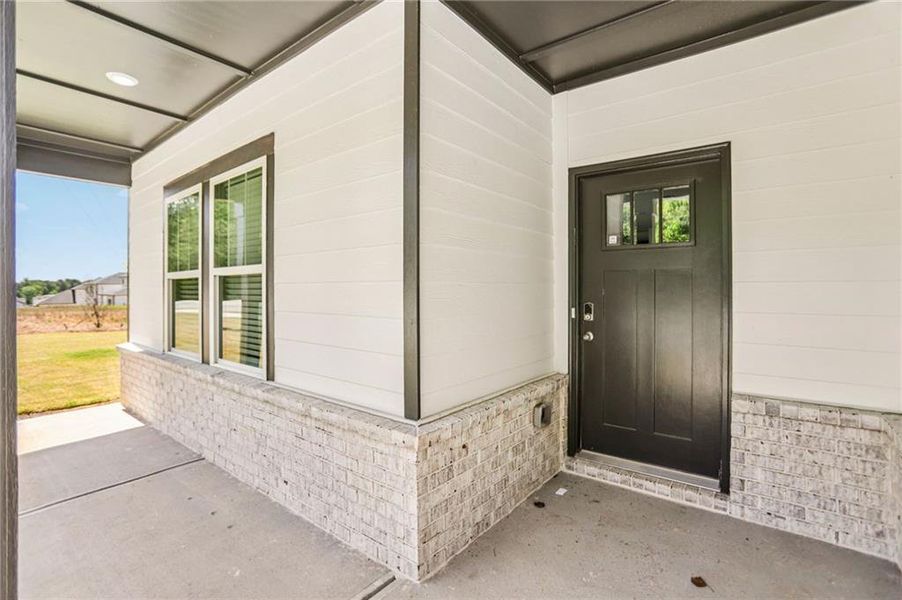 Exterior details and patio area of a home in Avalon - Vista Series, Conyers (Image 4).