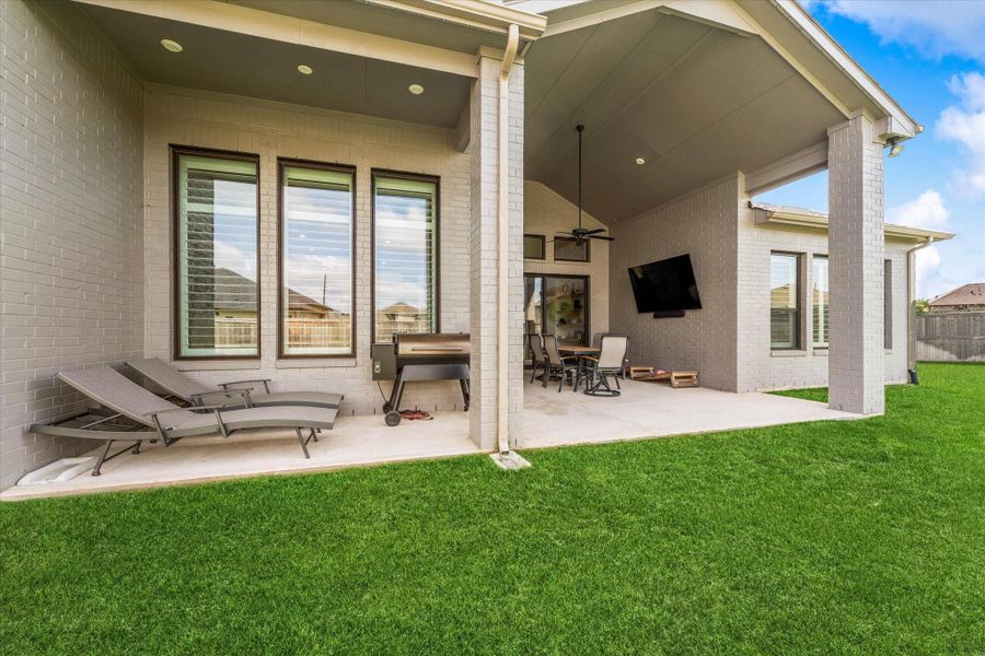 The covered patio creates the perfect setting for outdoor dining, relaxing evenings, or weekend gatherings year-round.