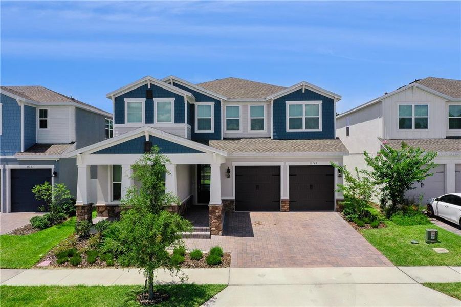 Front exterior of a new home in Horizon Isle, Winter Garden, FL, highlighting curb appeal (Image 2). Front exterior of a new home in Horizon Isle, Winter Garden, FL, highlighting curb appeal (Image 2).