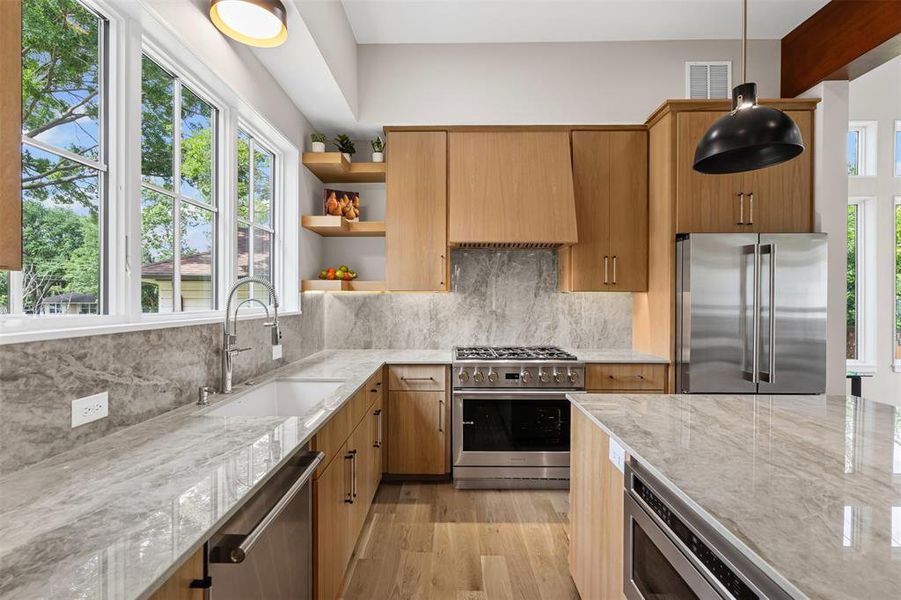 Custom white oak cabinetry with age-in-place pull-out shelves, and a Brizo polished nickel faucet.