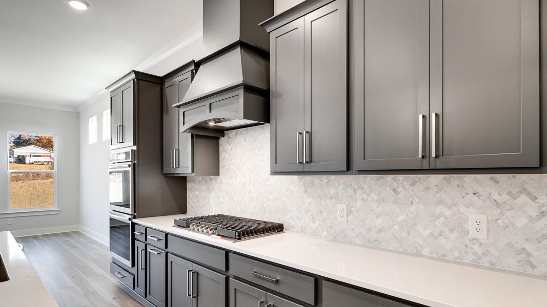 Gas range with designer backsplash and gray cabinetry