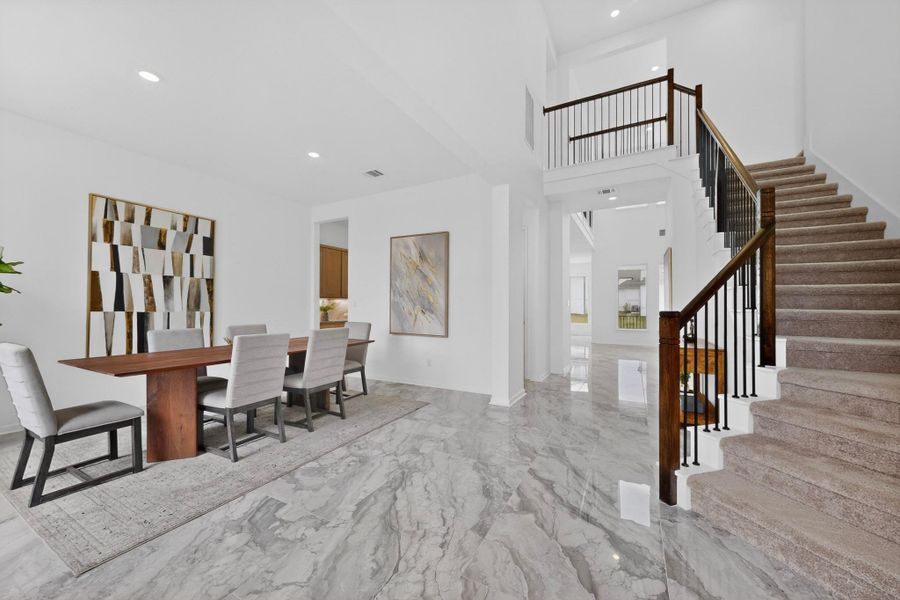 Expansive interior featuring high ceilings, light-hued walls, and elegant grey-toned flooring