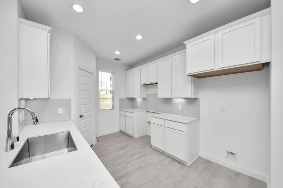 The extended counter area adds both practicality and style, making meal preparation a breeze. Every detail is thoughtfully designed to enhance the kitchen's functionality and aesthetic appeal. Sample photo of completed home with similar floor plan. Actual colors and selections may vary.