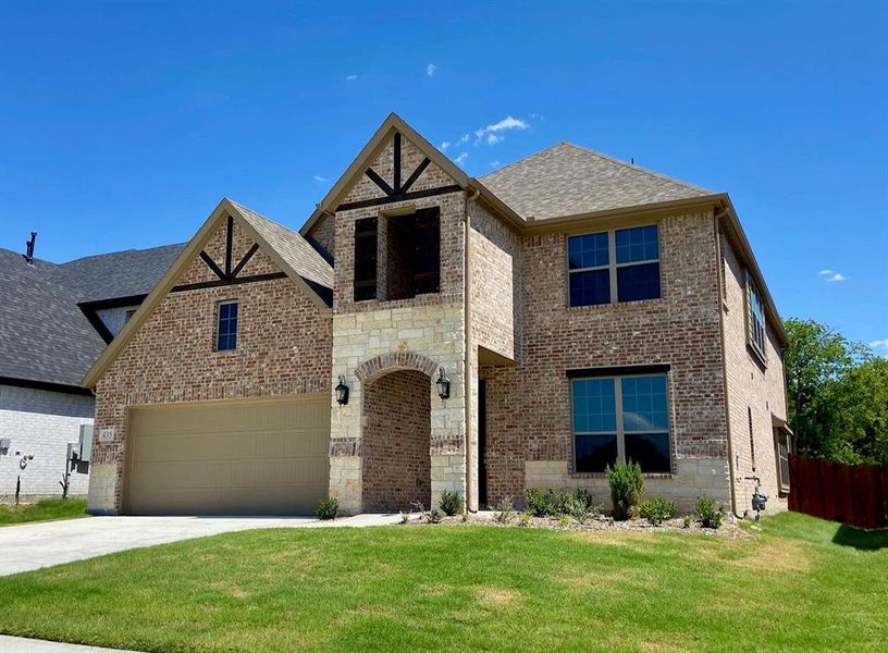 Elegant home with cedar inlay in gables and stone accents.