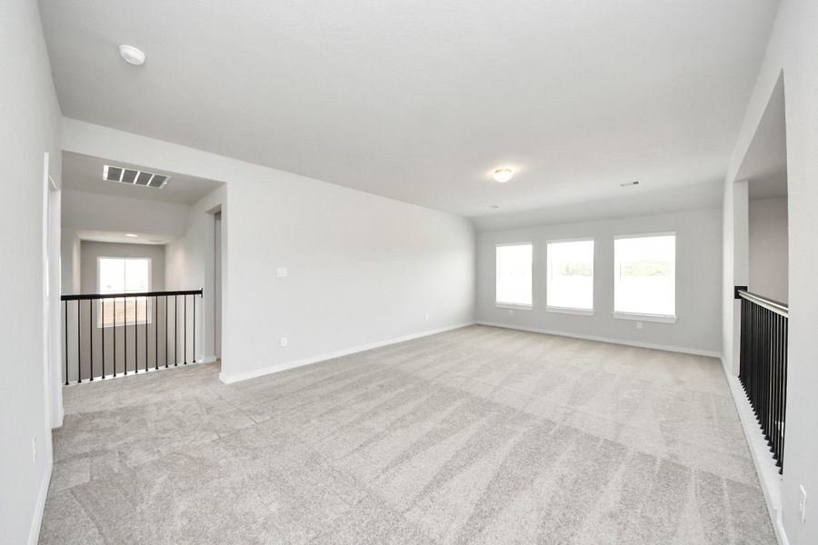 Ascend to relaxation in this fantastic game room! Ideal for both casual gatherings and adult gaming, it boasts plush carpet, lofty ceilings, custom paint, and ample windows for abundant natural light. Sample photo of completed home with similar floor plan. Actual colors and selections may vary. Ascend to relaxation in this fantastic game room! Ideal for both casual gatherings and adult gaming, it boasts plush carpet, lofty ceilings, custom paint, and ample windows for abundant natural light. Sample photo of completed home with similar floor plan. Actual colors and selections may vary.