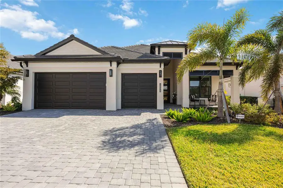 Front exterior of a new home in Gran Place, Venice, FL, highlighting curb appeal (Image 21).