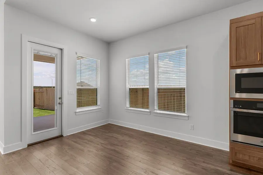 A well-lit dining area features ample natural light and direct access to the yard.