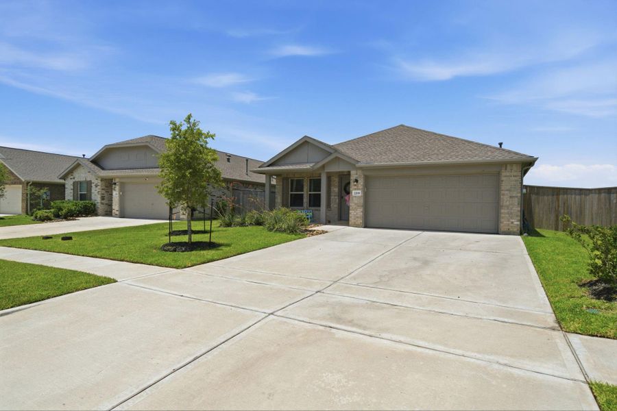 Front exterior of a new home in Samara, League City, TX, highlighting curb appeal (Image 2). Front exterior of a new home in Samara, League City, TX, highlighting curb appeal (Image 2).