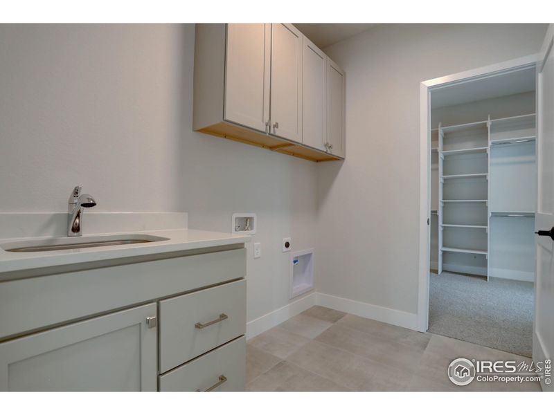 Laundry room with sink on upper level