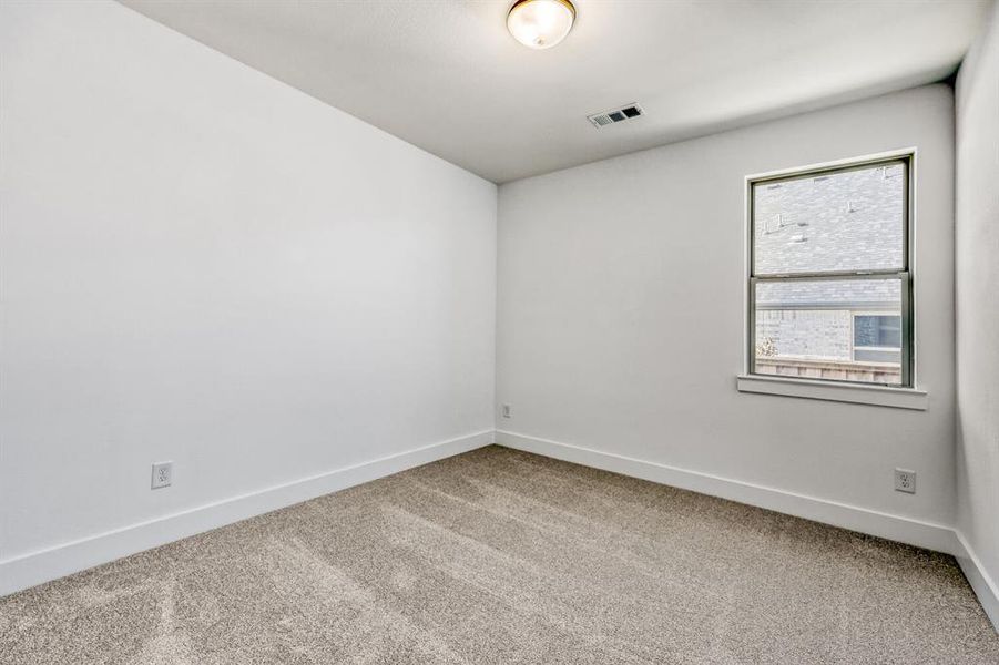 Unfurnished room with light carpet and baseboards