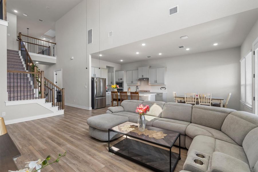 High ceilings and continuous wood flooring define this open-concept main level layout.