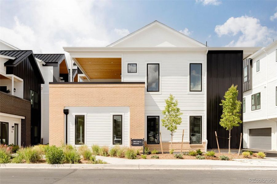 Front exterior of a new home in A Line Townhomes, Denver, CO, highlighting curb appeal (Image 1).