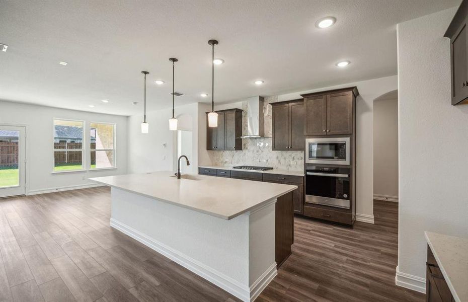 Bright kitchen with oversized island and ample cabinet space *real home pictured