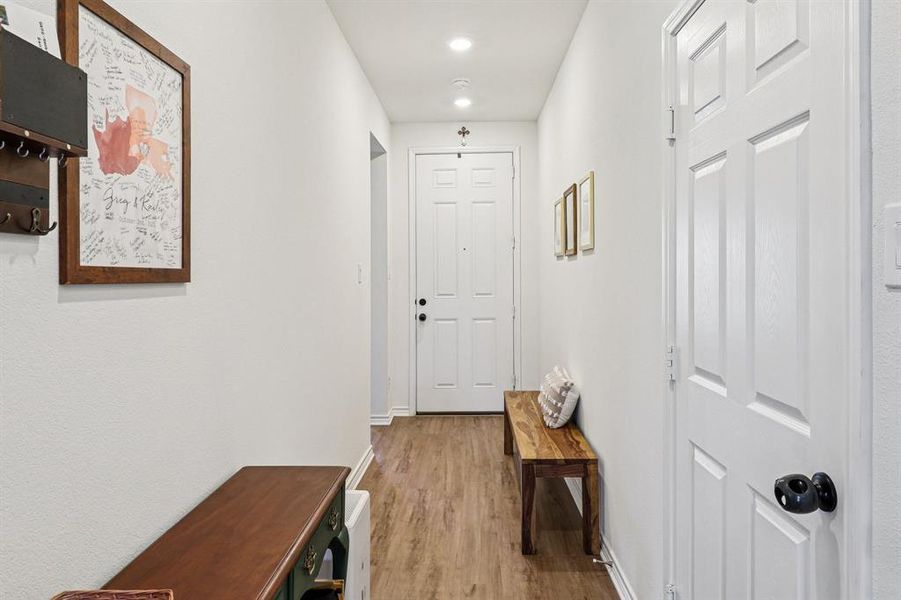 Corridor featuring light wood-style floors and recessed lighting Corridor featuring light wood-style floors and recessed lighting