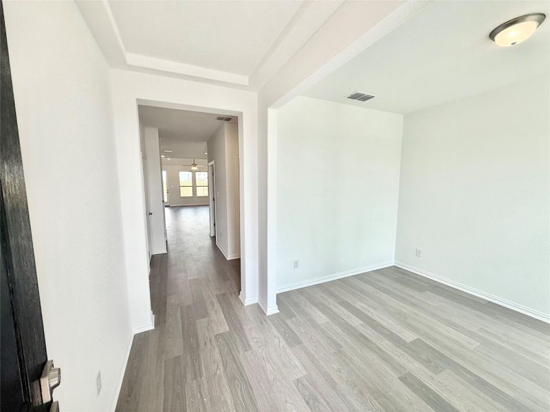 Unfurnished room with light wood-type flooring and baseboards Unfurnished room with light wood-type flooring and baseboards