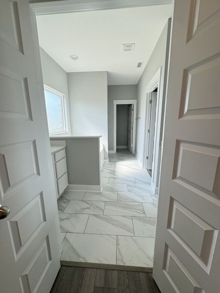 View from primary bedroom looking into primary bathroom.

*Photo is from a previous listing displaying the completed floor plan some options and selections may vary from actual home.