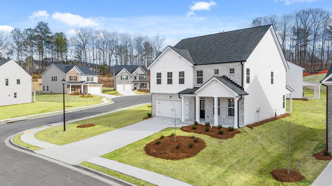 Front exterior of a new home in Evergreen Crossing, Locust Grove, GA, highlighting curb appeal (Image 2).