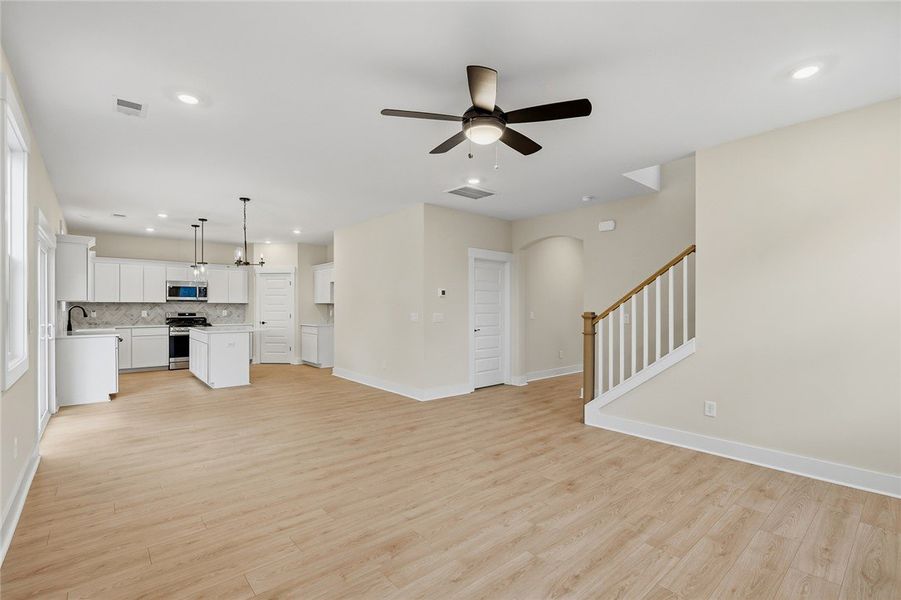 An open floorplan seamlessly connects the airy liv