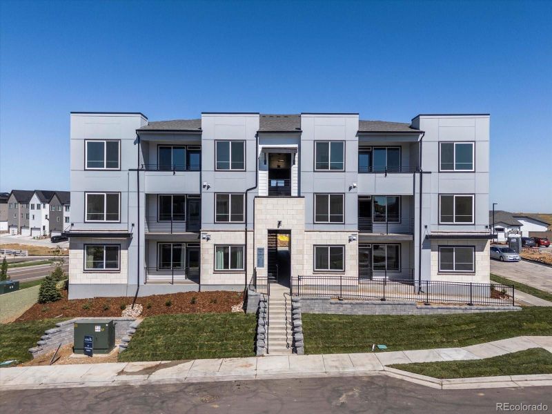 Front exterior of a new home in Lyric at RidgeGate Condos, Lone Tree, CO, highlighting curb appeal (Image 13).
