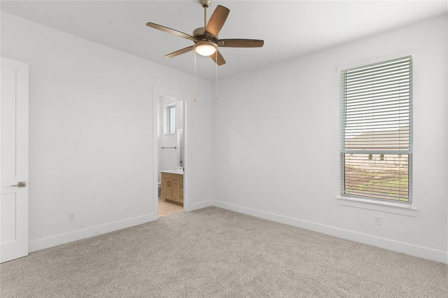 Unfurnished *PHOTO REPRESENTATIVE OF FLOORPLAN ONLY*with ensuite bath, multiple windows, light colored carpet, and ceiling fan