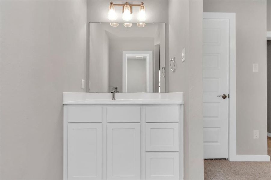 Elevating daily routines with a touch of sophistication – the sleek and functional vanity area in our Jack and Jill bedroom arrangement. Where style meets convenience. Sample photo of completed home with similar floor plan. As-built interior colors and selections may vary.