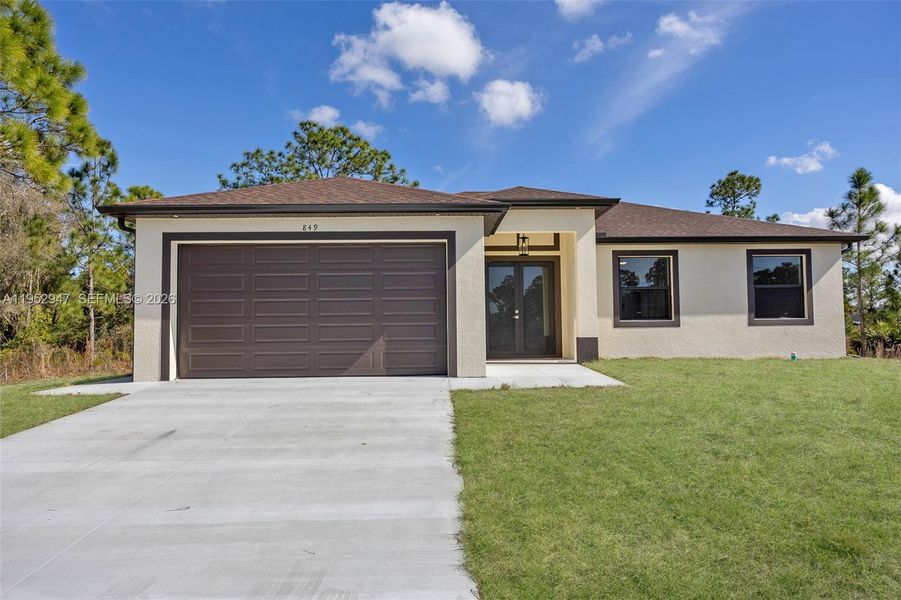 Front exterior of a new home in , Lehigh Acres, FL, highlighting curb appeal (Image 18).